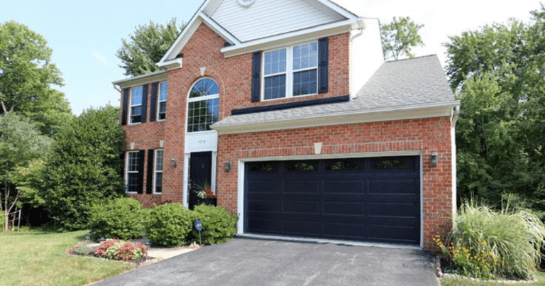 black garage doors on red brick house