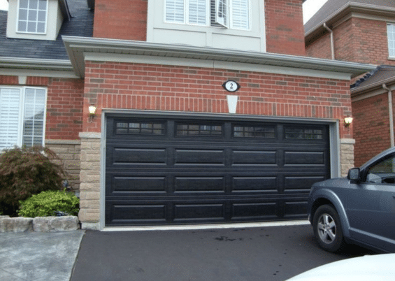 red brick house with black garage door